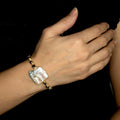 Calau Bracelet on a model. Gold Color  Bracelet with Purple beads crystals and Fresh Water Pearl. Wire wrapped bracelet.