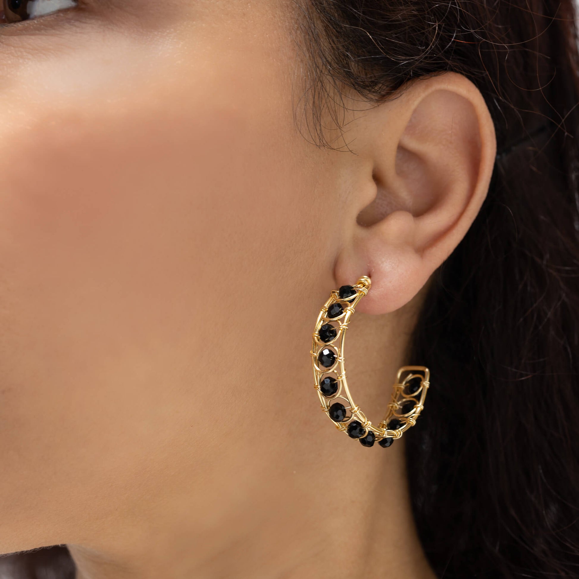 Catania Hoop Earrings on a model. Gold Color Wire with Black Crystal Beads. Wire Wrapped Earrings.