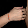 Siegen Silver Bracelet on a model. Silver Color Cuff Bracelet with Orange seed beads crystals. Wire wrapped bracelet.