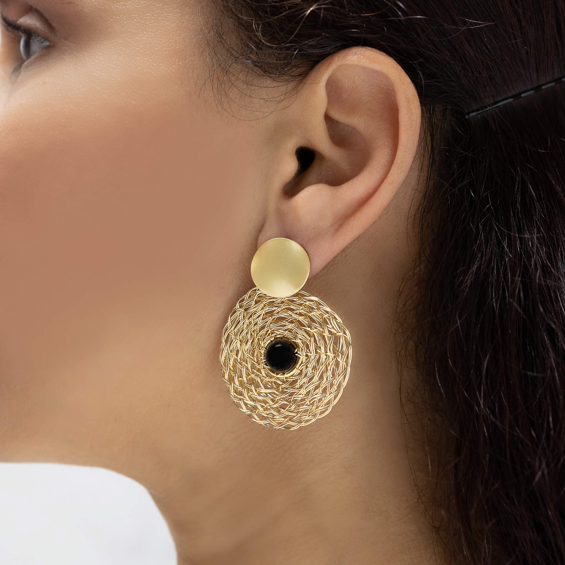 Muret Earrings on a model. Gold Color Earrings with Black Onyx Round Bead. Stud Earrings. Wire Wrapped Earrings.