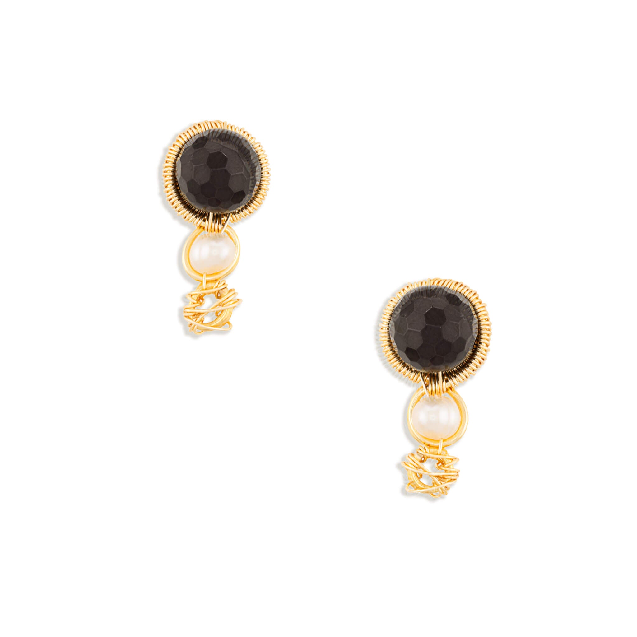 A pair of gold drop earrings featuring round dark red faceted Garnet gemstones, a small white pearl, and a dangling gold filigree charm, shown on a plain white background.