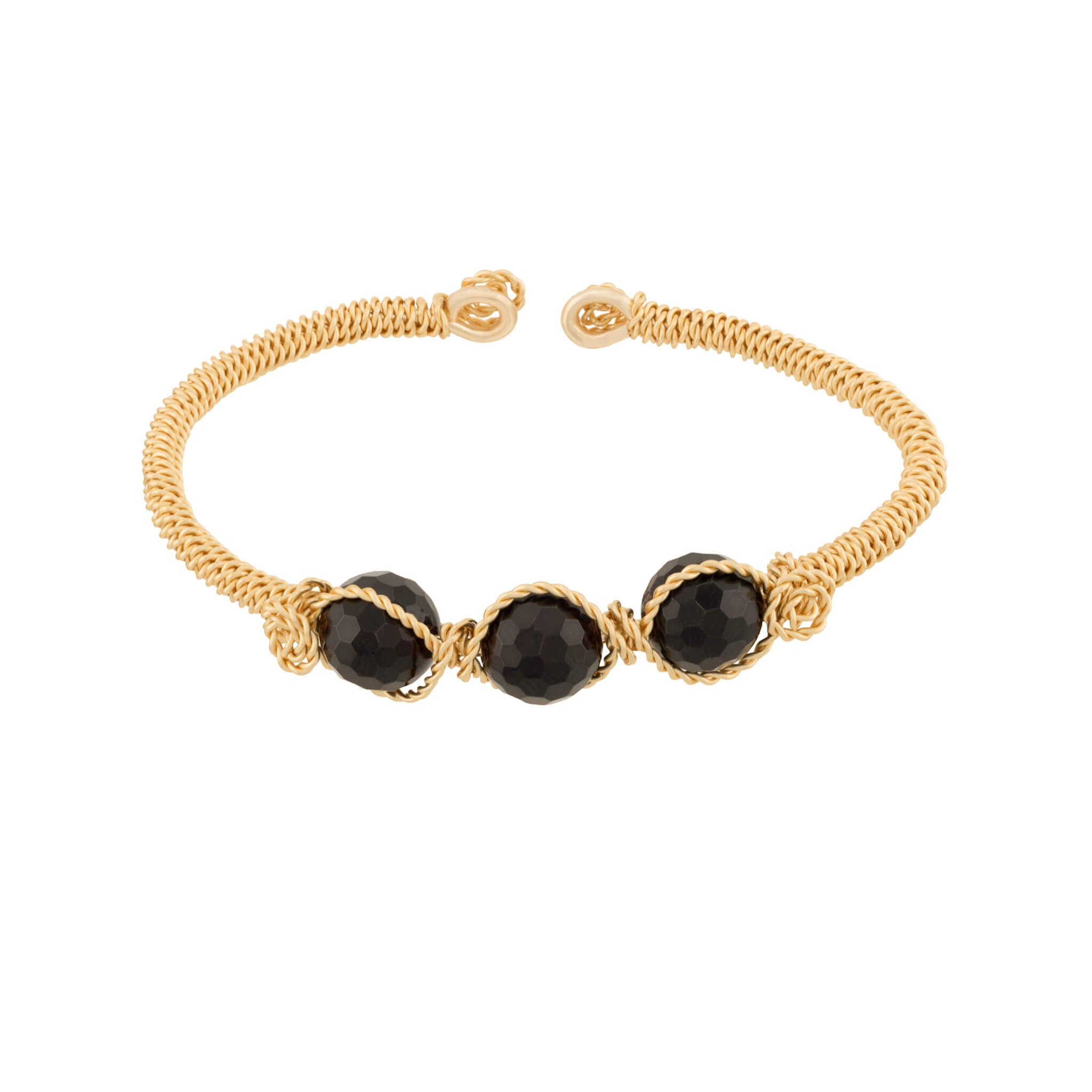A gold wire-wrapped cuff bracelet featuring three faceted dark red Garnet gemstone beads spaced, displayed on a clean white background.