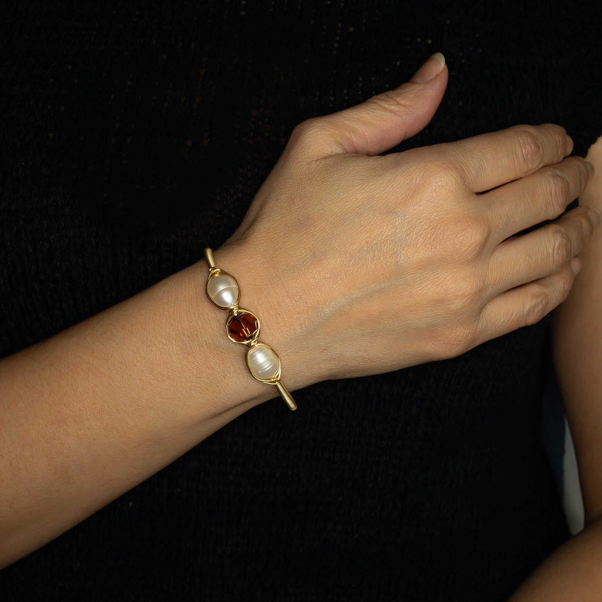 November Birthstone Crystal Gold Bracelet on a model. Brown Crystals, Fresh Water Pearls  and Non tarnish Gold color wire. Wire Wrapped Bracelet.