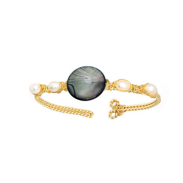 Dorfen Bracelet is one size fits all. Gold, black and white bracelet. Handmade with Non-tarnish Gold plated wire, mother pearls, and Fresh Water Pearls. Wire-wrapped bracelet.
