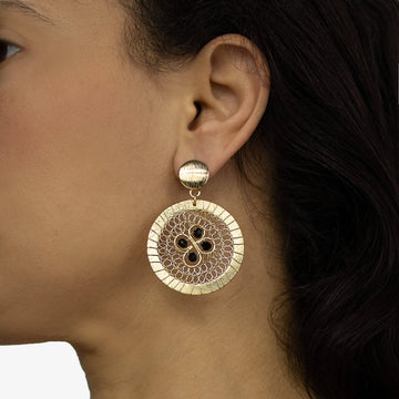 Chadna Earrings on a model. Gold Color Earrings with Black Crystal Beads. Round Stud Earrings. Metal Frame & Wire Wrapped Earrings.