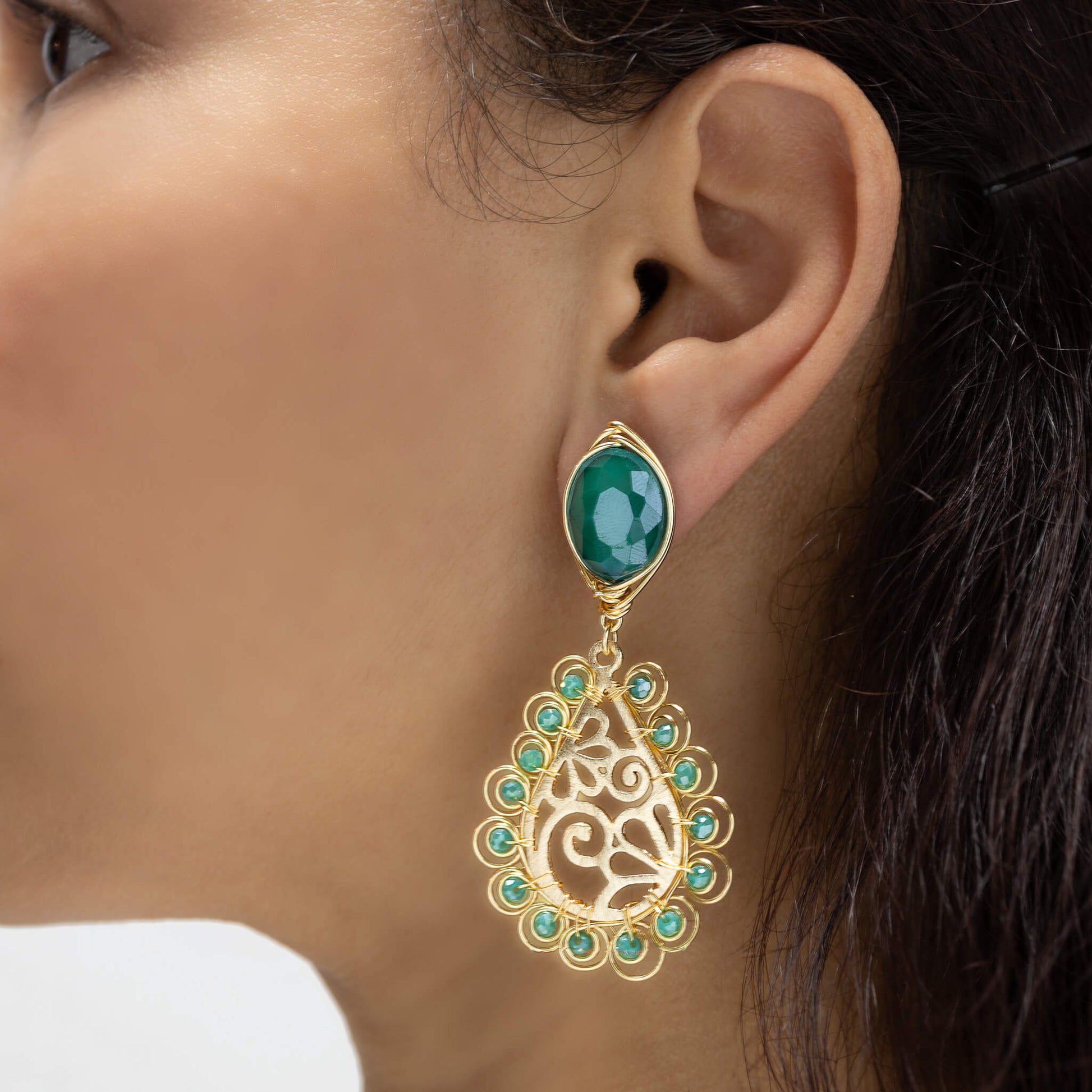 Ekani  Earrings on a model.  Gold Color Earrings with Green Crystals . Stud Earrings. Metal Frame & Wire Wrapped Earrings