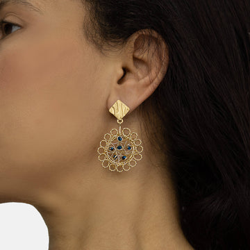 Haimi Earrings on a model. Gold Color Wire Wrapped Earrings. Stud Earrings with Metallic Blue Crystal Beads Accent.
