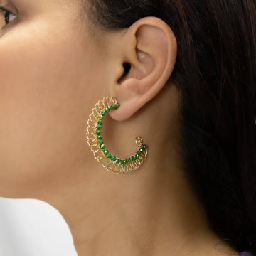 Bari Hoop Earrings on a model. Gold Color Earrings with Green Crystal Beads Wire Wrapped Hoop Earrings.