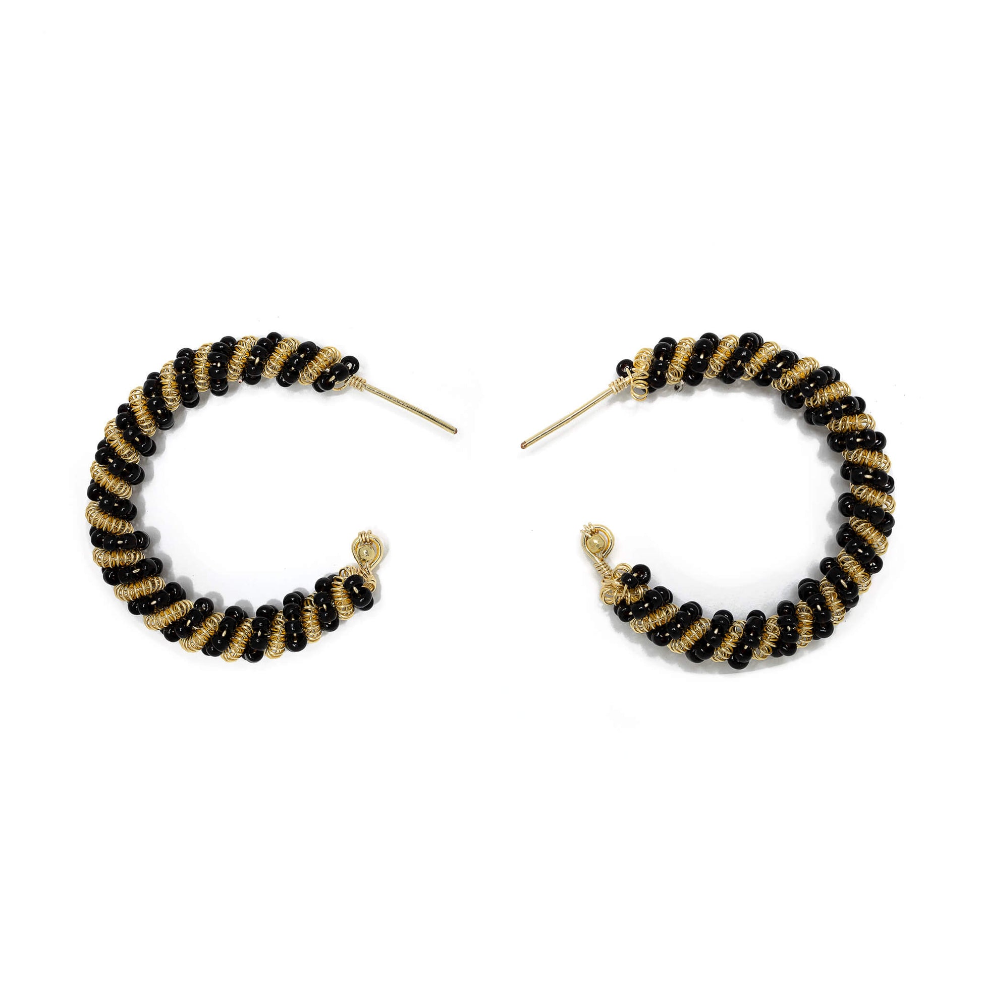 The Milan Hoop Earrings are 1.5 inches long. Minimalist Gold and black earrings. Wire Wrapped Earrings. Handmade Gold beaded earrings. Feature gold-plated wire and Czech seed bead crystals. Wire earrings.