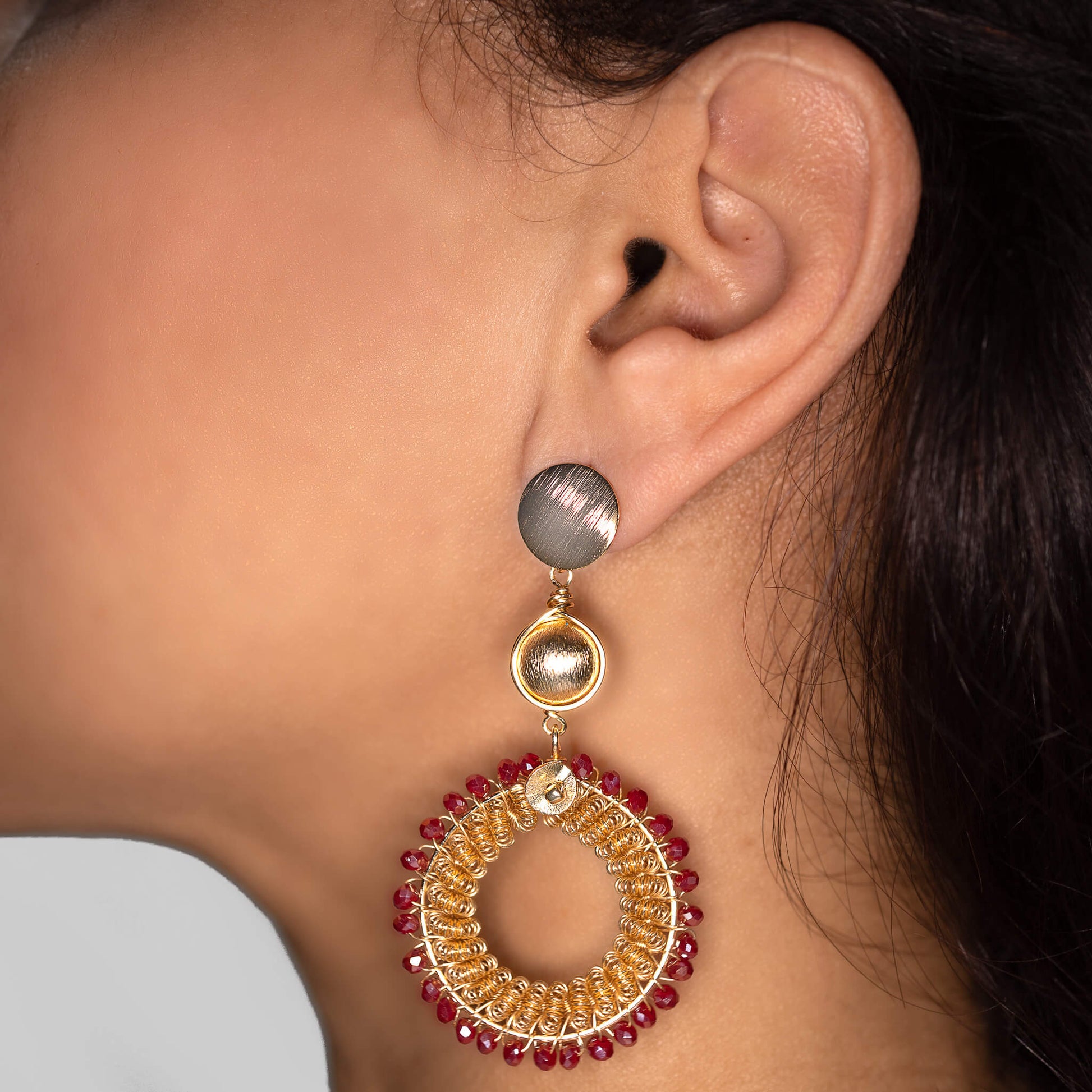 Jalsa Earrings on a model. Gold Color Earrings with Fushia Crystal Seed Beads. Stud Earrings. Metal Frame & Wire Wrapped Earrings