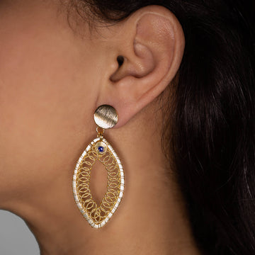 Lana Earrings on a model. Gold Color Earrings with Blue  Crystal Bead. Stud Earrings. Metal Frame & Wire Wrapped Earrings