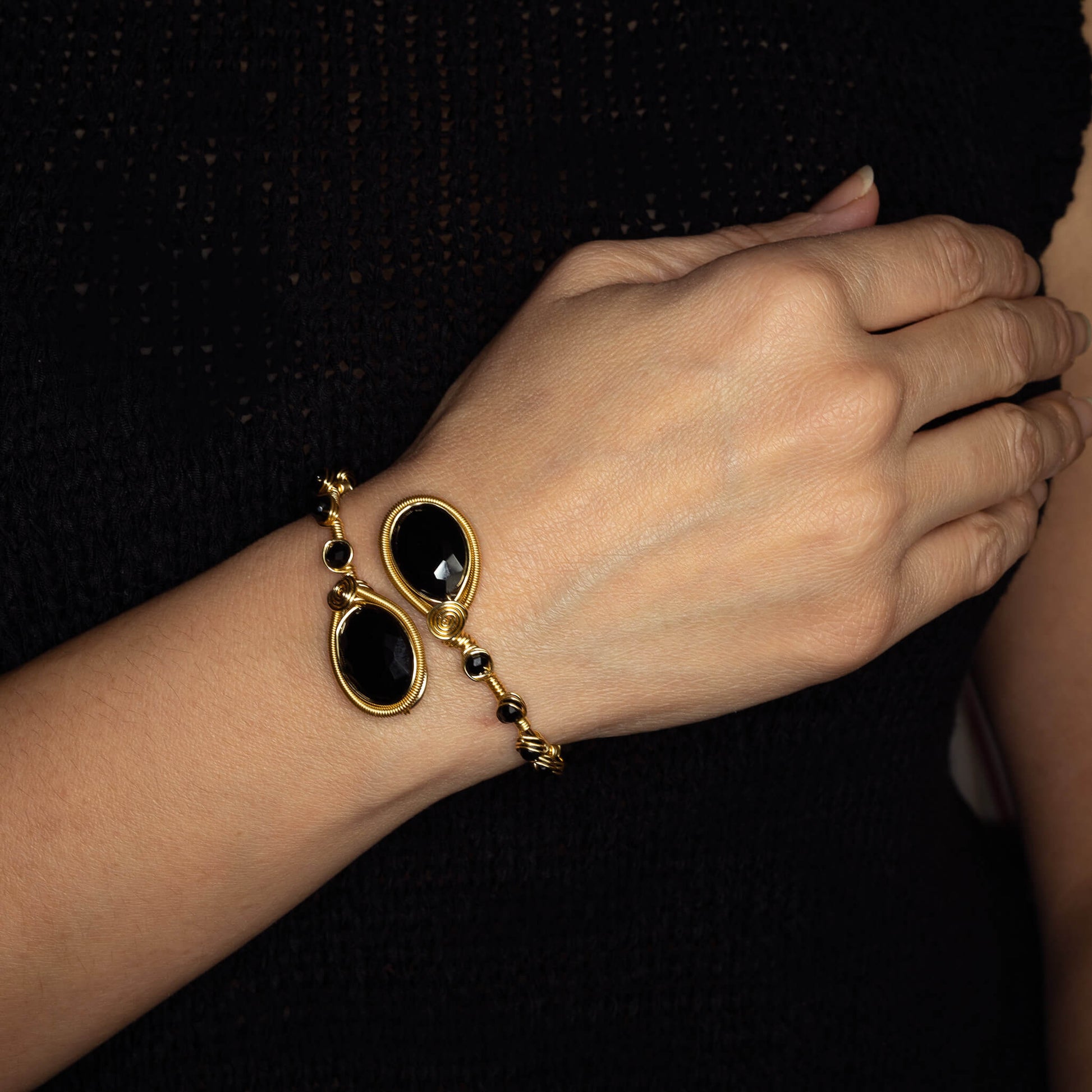 Neuss Bracelet on arm model. Gold Color  Bracelet with Black beads crystals. Wire wrapped bracelet. 