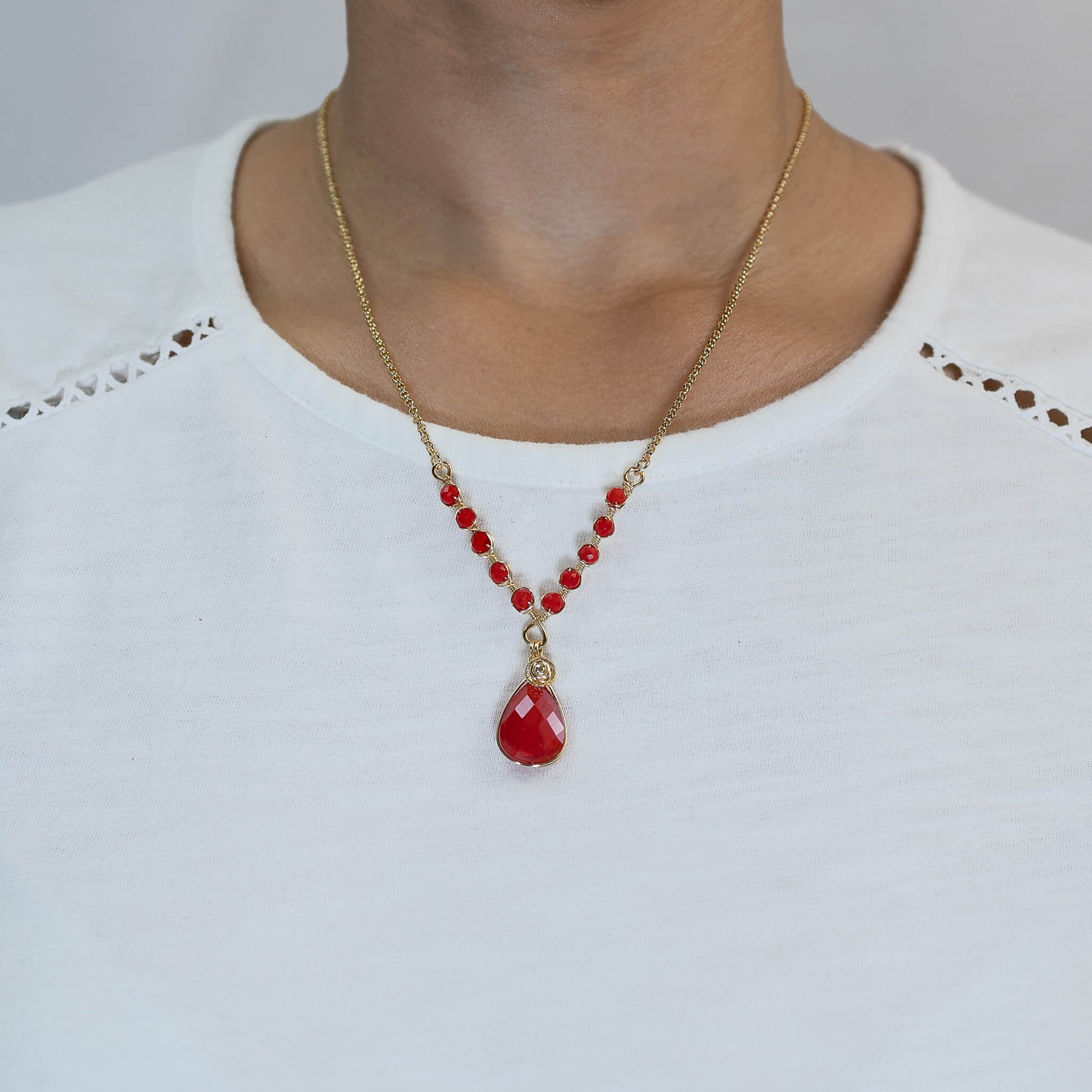 Victoria Necklace on a model. Red and Gold Necklace. 22K Gold Plated Chain. 